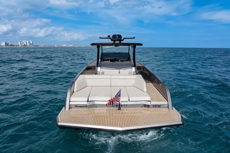 Slide: The Image of 2022 Vanquish VQ40 luxury yacht on open sea, rear view with American flag. - 38