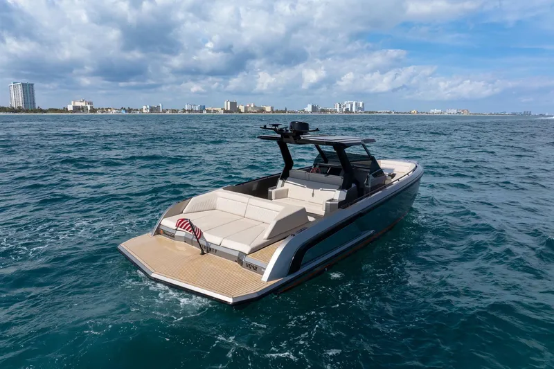 Slide: The Image of 2022 Vanquish VQ40 luxury yacht cruising on open water with city skyline backdrop. - 39