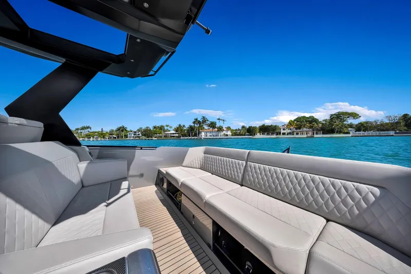 Slide: The Image of Luxurious 2022 Vanquish VQ40 yacht interior with elegant seating, overlooking serene waterfront views. - 42
