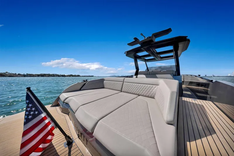 Slide: The Image of Luxurious 2022 Vanquish VQ40 yacht with spacious deck and American flag on open water. - 47
