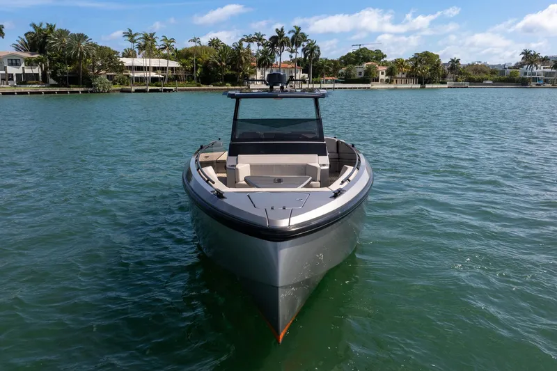 Slide: The Image of 2022 Vanquish VQ40 luxury yacht on serene water with palm trees in the background. - 5