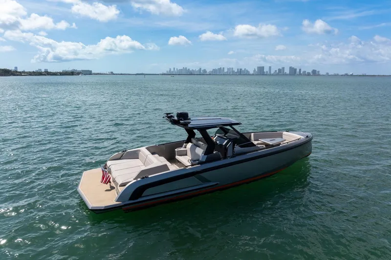 Slide: The Image of 2022 Vanquish VQ40 boat on calm water with city skyline in background. - 50