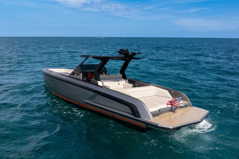 Slide: The Image of 2022 Vanquish VQ40 luxury yacht cruising on open sea with American flag. - 52