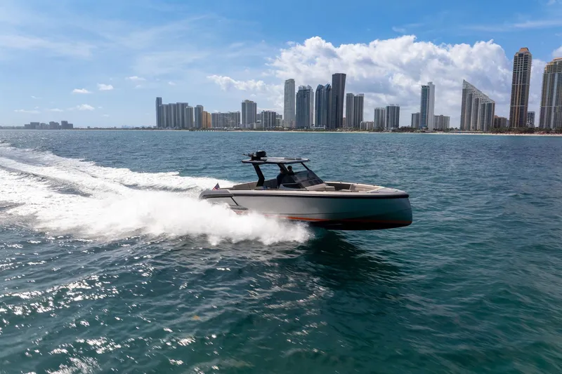 Slide: The Image of 2022 Vanquish VQ40 yacht cruising near city skyline on a sunny day. - 55