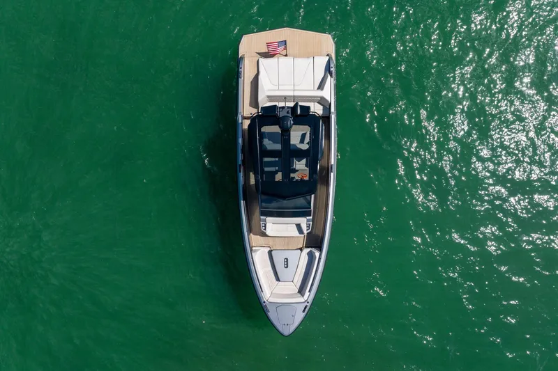 Slide: The Image of Aerial view of 2022 Vanquish VQ40 yacht on vibrant green water. - 8