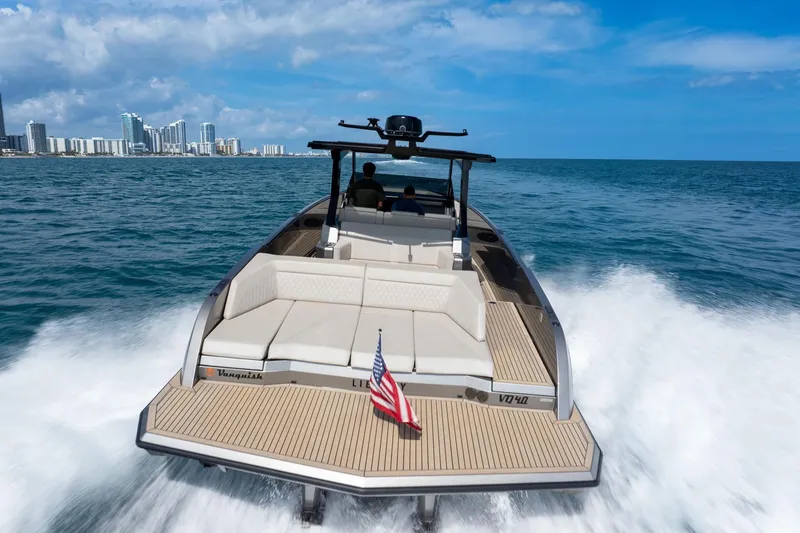 Slide: The Image of 2022 Vanquish VQ40 luxury yacht cruising near city skyline on a sunny day. - 9