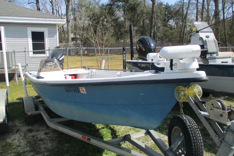 Slide: The Image of 2012 Stumpknocker 17 SPORT boat on trailer, parked outdoors near a house. - 2