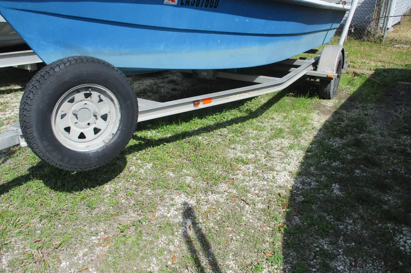 Slide: The Image of 2012 Stumpknocker 17 SPORT boat on trailer, parked on grassy area. - 3