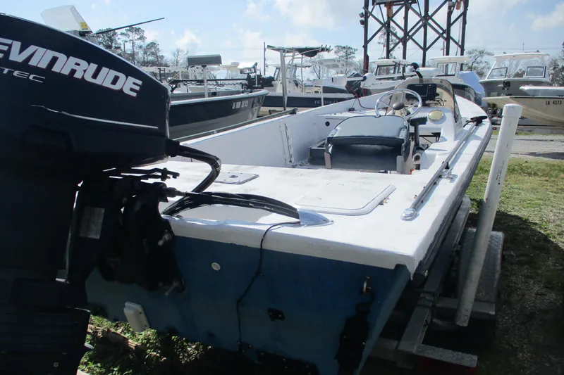 Slide: The Image of 2012 Stumpknocker 17 SPORT boat with Evinrude motor, parked on a trailer. - 5