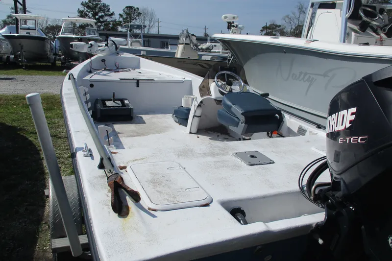 Slide: The Image of 2012 Stumpknocker 17 SPORT boat with Evinrude E-TEC engine, parked among other boats. - 8