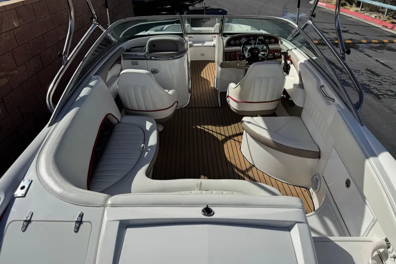 Slide: The Image of 2004 Cobalt 240SD boat interior with white seating and wood flooring. - 11