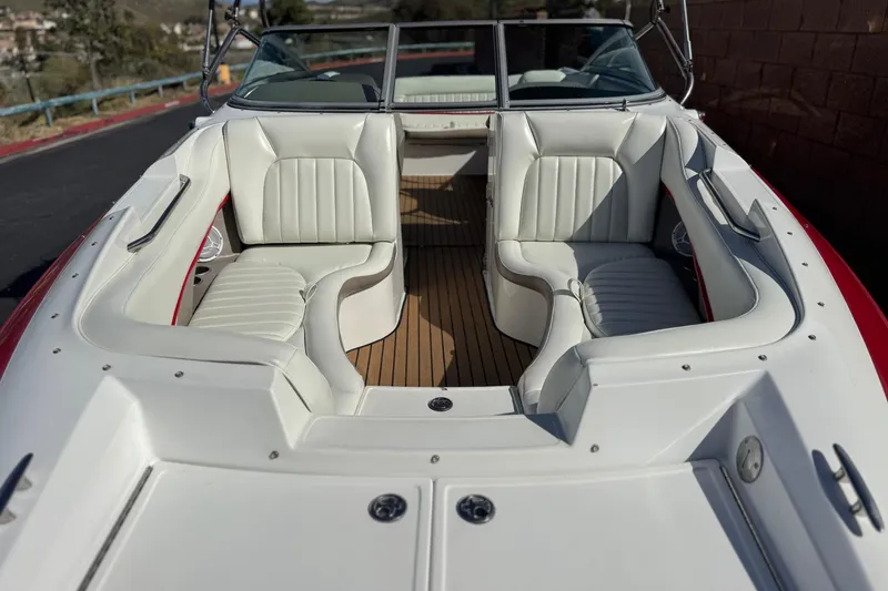 Slide: The Image of 2004 Cobalt 240SD boat interior with white leather seating and wooden flooring. - 12