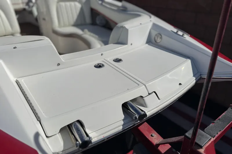 Slide: The Image of 2004 Cobalt 240SD boat interior with white seating and storage compartments. - 13