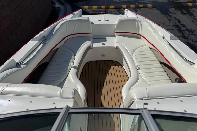 Slide: The Image of 2004 Cobalt 240SD boat interior with white leather seating and wooden flooring. - 15