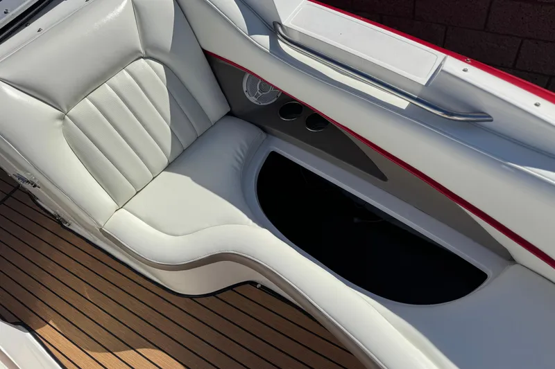 Slide: The Image of Interior of a 2004 Cobalt 240SD boat with white leather seating and wood flooring. - 17