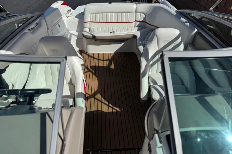 Slide: The Image of 2004 Cobalt 240SD boat interior with white seating and wooden flooring. - 18