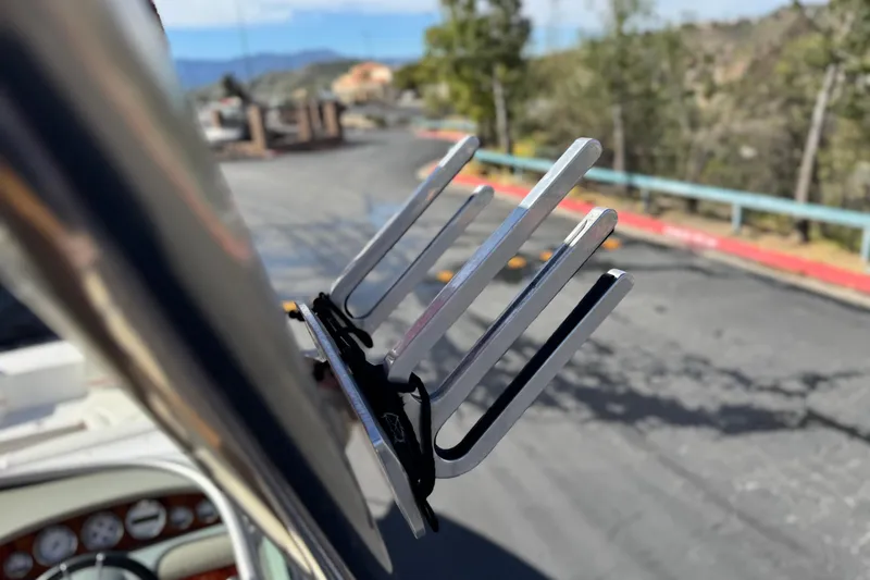 Slide: The Image of Close-up of a 2004 Cobalt 240SD boat's wakeboard rack against a scenic background. - 20