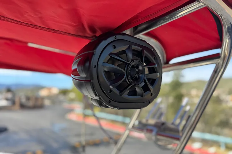 Slide: The Image of Black speaker mounted on a 2004 Cobalt 240SD boat with red canopy. - 21