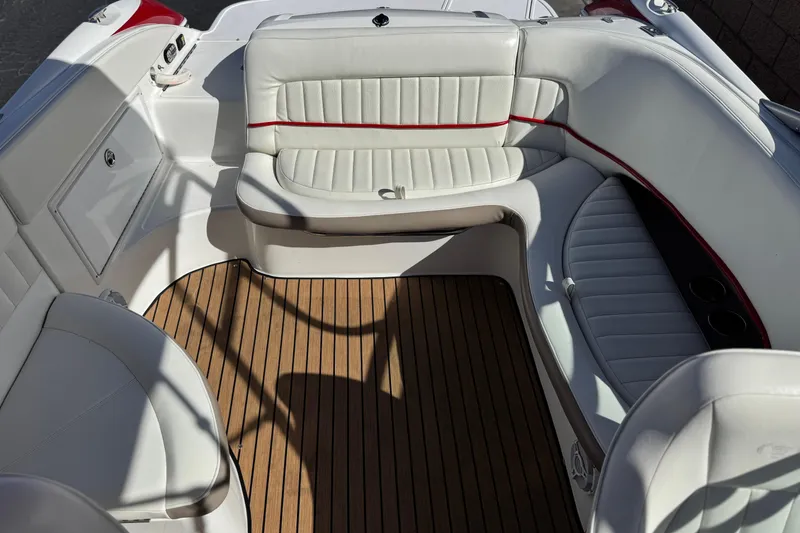 Slide: The Image of 2004 Cobalt 240SD boat interior with white seating and wood flooring. - 22
