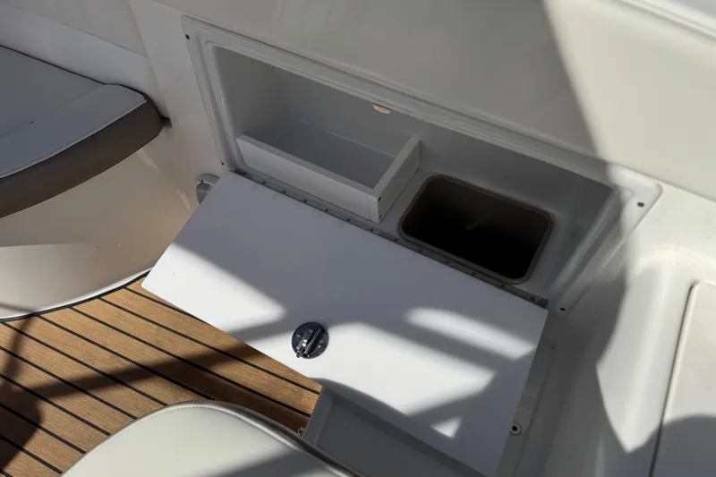 Slide: The Image of 2004 Cobalt 240SD boat interior storage compartment with wooden flooring. - 23