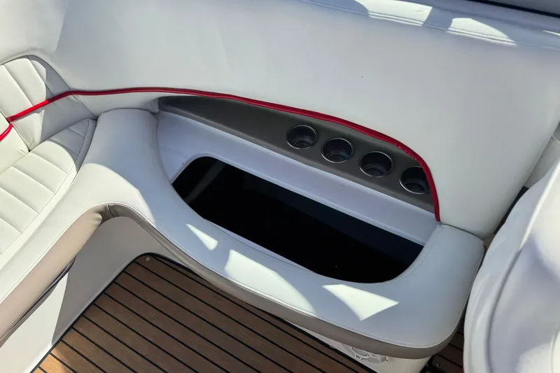 Slide: The Image of Interior of 2004 Cobalt 240SD boat with white seating and cup holders. - 25