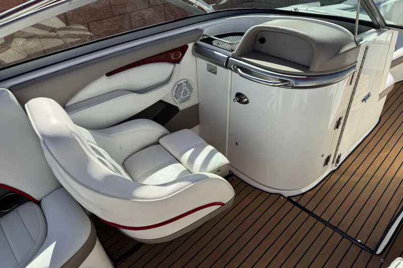Slide: The Image of Interior of a 2004 Cobalt 240SD boat with white seating and wood flooring. - 28