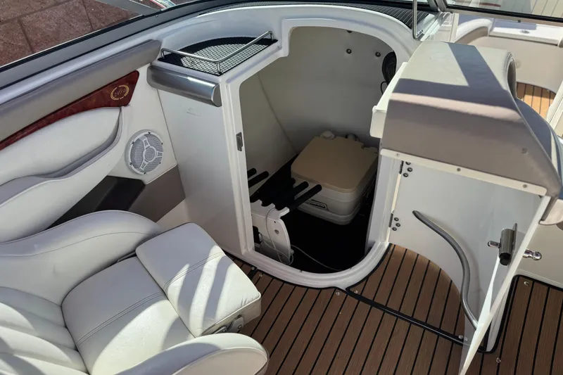 Slide: The Image of 2004 Cobalt 240SD boat interior with seating and storage compartment. - 30