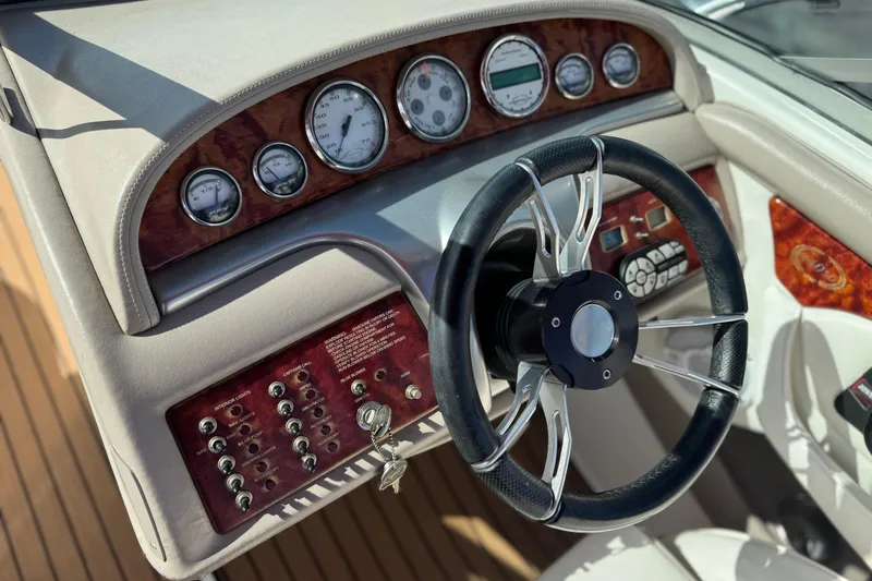 Slide: The Image of 2004 Cobalt 240SD boat dashboard with steering wheel and instrument panel. - 34