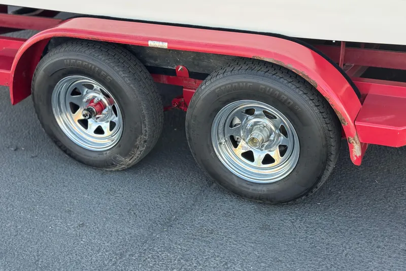 Slide: The Image of Red trailer with dual wheels for 2004 Cobalt 240SD boat. - 35