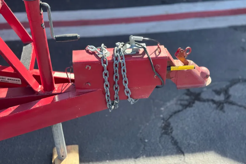 Slide: The Image of Red trailer hitch with chains and crank handle, Cobalt 240SD, 2004 model. - 37