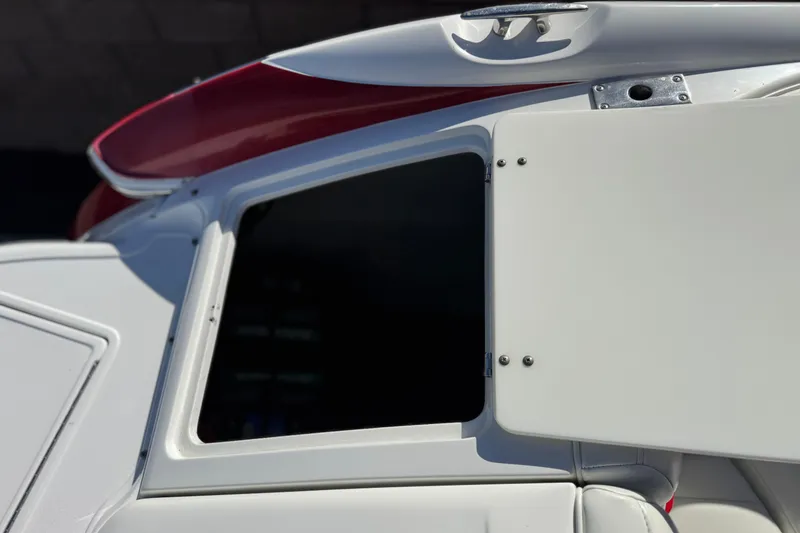 Slide: The Image of 2004 Cobalt 240SD boat with open storage compartment and sleek design. - 9