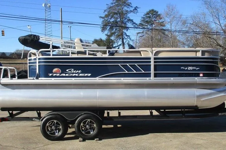 Slide: The Image of 2022 Sun Tracker Party Barge 20 DLX pontoon boat on trailer, parked outdoors. - 5