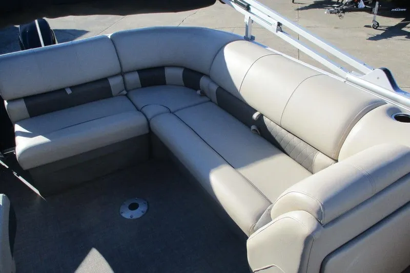 Slide: The Image of 2022 Sun Tracker Party Barge 20 DLX interior with plush seating and cup holder. - 6