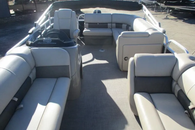 Slide: The Image of 2022 Sun Tracker Party Barge 20 DLX interior with spacious seating and helm. - 9