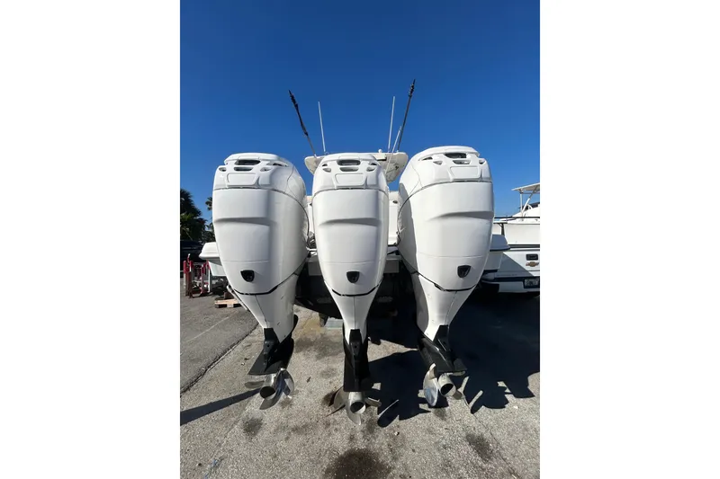 Slide: The Image of Three powerful outboard motors on a 2012 Boston Whaler 370 Outrage boat. - 2