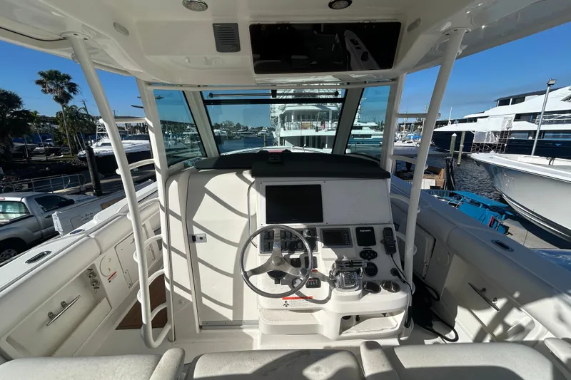 Slide: The Image of 2012 Boston Whaler 370 Outrage helm with steering wheel and navigation controls. - 6