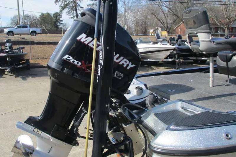 Slide: The Image of 2011 Triton 21XS Elite boat with Mercury Pro XS engine in a parking lot. - 2