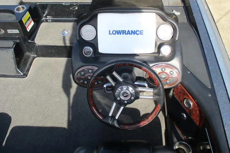 Slide: The Image of 2011 Triton 21XS Elite boat dashboard with Lowrance display and steering wheel. - 5