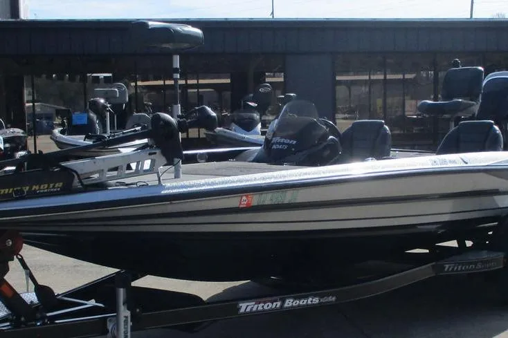 Slide: The Image of 2011 Triton 21XS Elite boat on trailer, parked outdoors. - 7