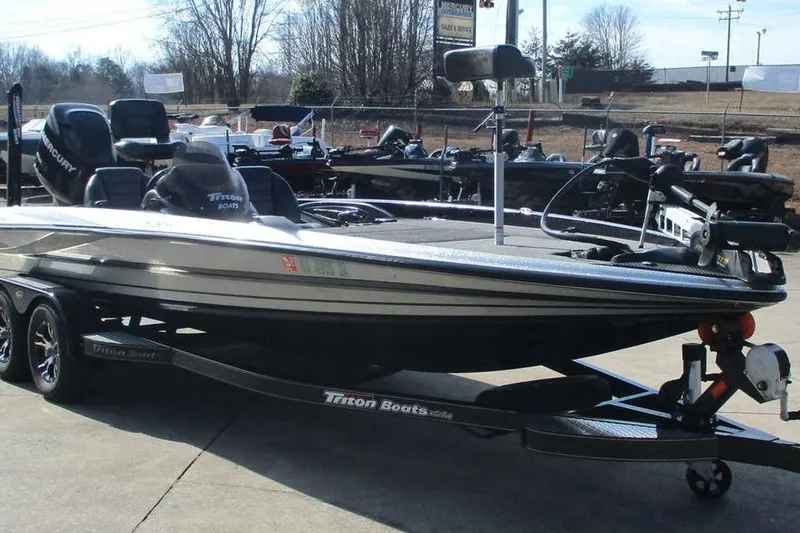 Slide: The Image of 2011 Triton 21XS Elite boat on trailer in outdoor setting. - 8