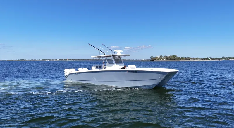 Slide: The Image of 2020 Invincible 37 Catamaran cruising on open water under clear blue skies. - 0
