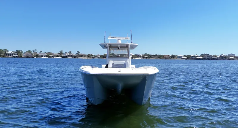 Slide: The Image of 2020 Invincible 37 Catamaran on water, clear sky, coastal background. - 1