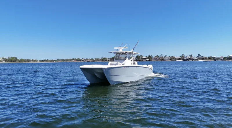 Slide: The Image of 2020 Invincible 37 Catamaran cruising on open water under clear blue sky. - 2