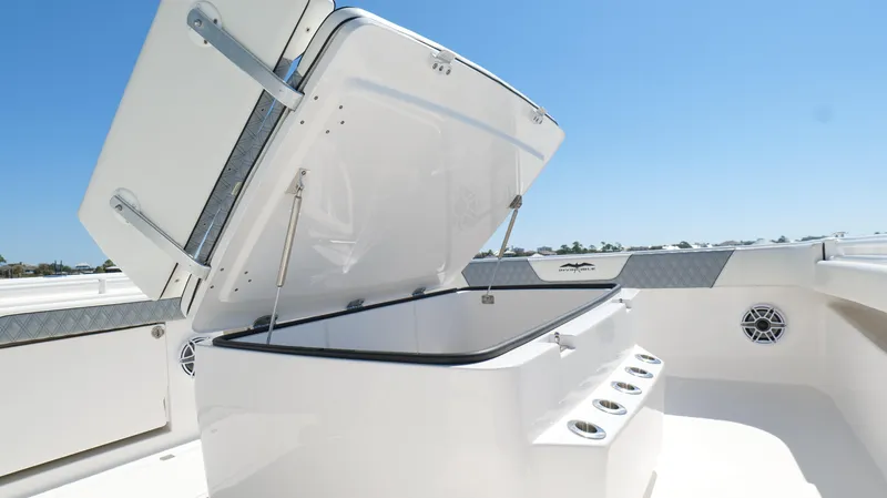 Slide: The Image of Open storage compartment on 2020 Invincible 37 Catamaran under clear blue sky. - 38