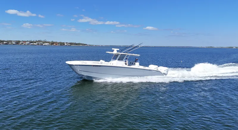 Slide: The Image of 2020 Invincible 37 Catamaran cruising on open water under clear blue skies. - 6