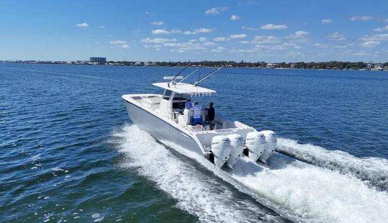 Slide: The Image of 2020 Invincible 37 Catamaran cruising on open water under a clear blue sky. - 8