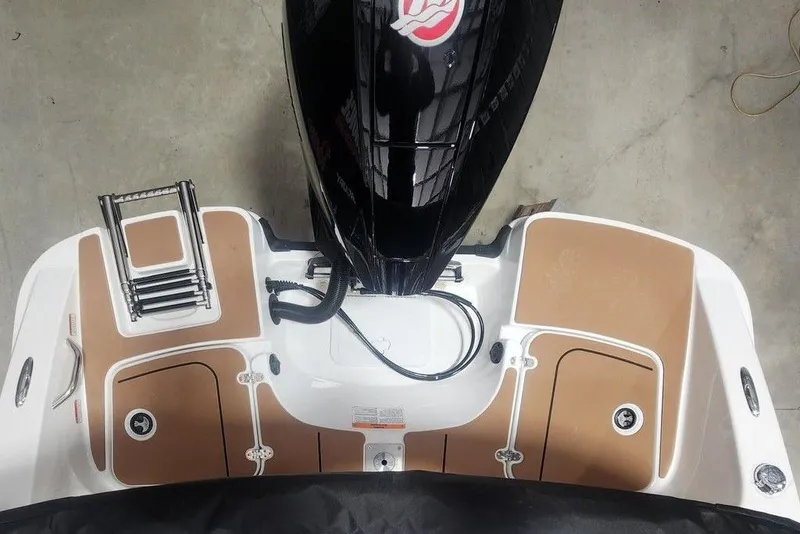 Slide: The Image of Top view of 2026 Tahoe 1950 boat's deck with motor and ladder. - 11