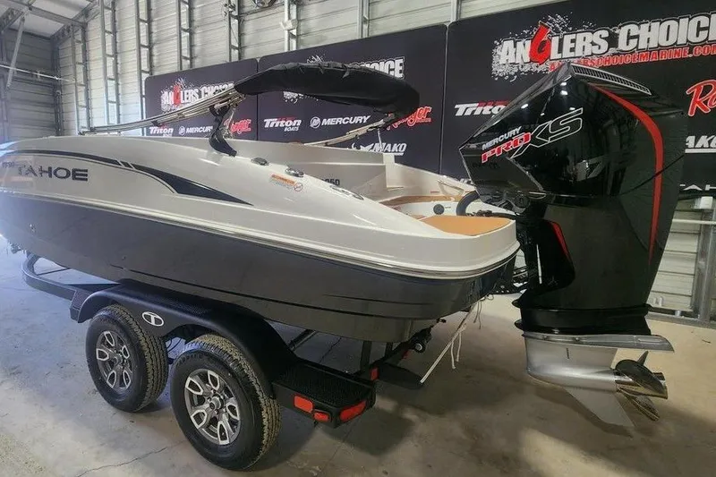 Slide: The Image of 2026 Tahoe 1950 boat with Mercury Pro XS engine on trailer in showroom. - 2
