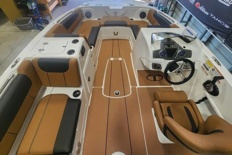 Slide: The Image of 2026 Tahoe 1950 boat interior with tan and black seating, modern dashboard, and spacious layout. - 3