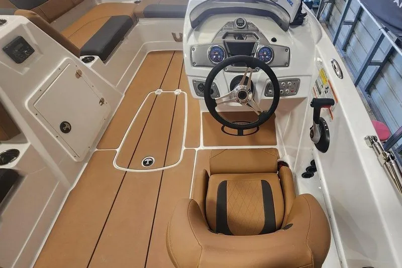 Slide: The Image of Interior of 2026 Tahoe 1950 boat with modern steering and tan seating. - 4
